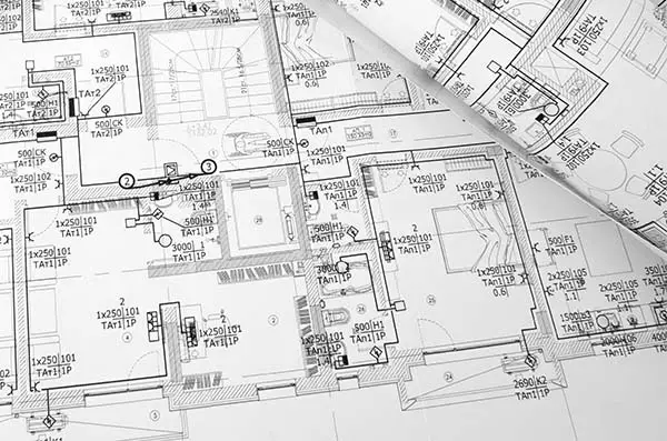 Electrical engineer reviewing industrial facility power distribution design drawings